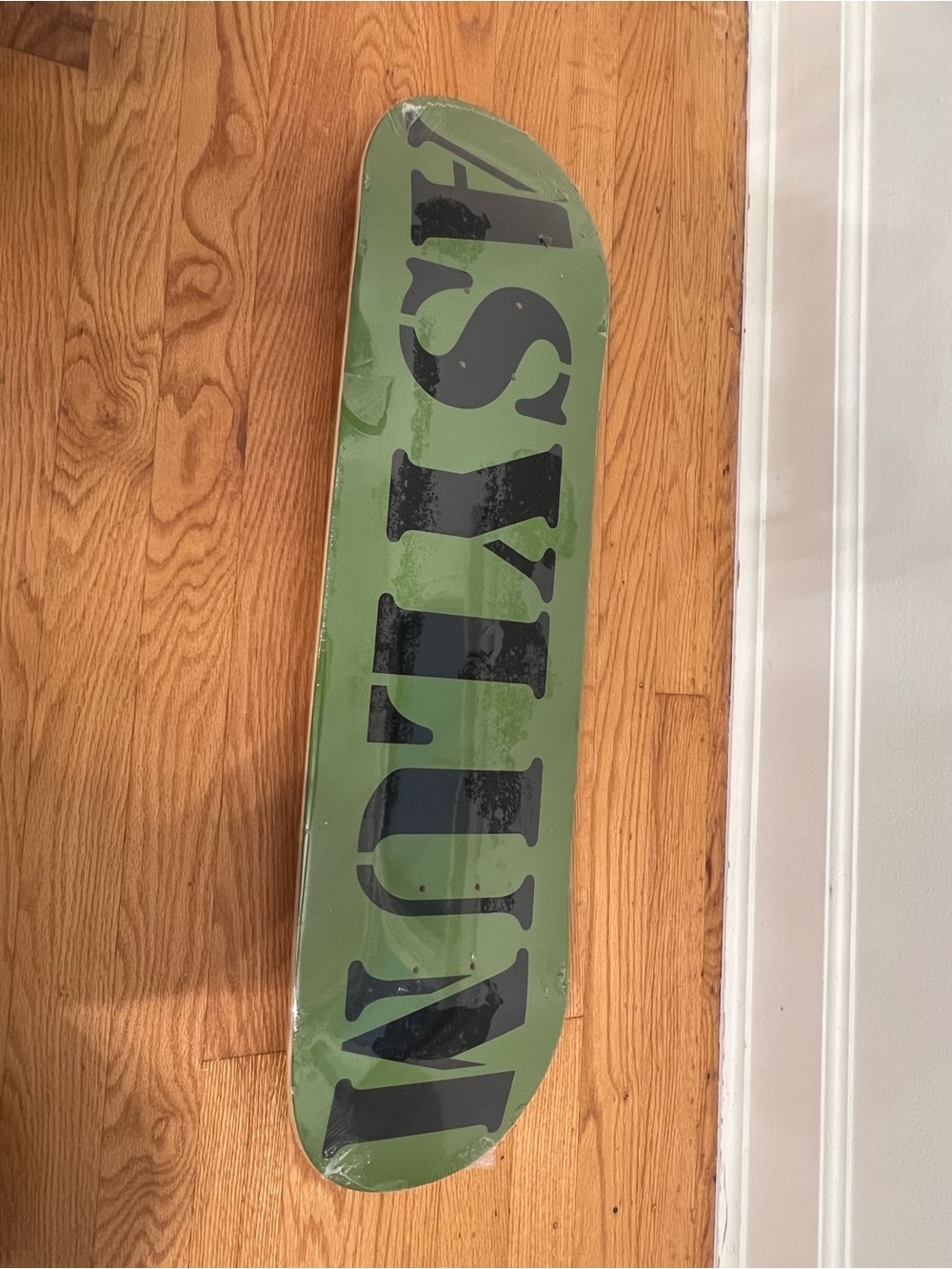 Asylum Green Skateboard Deck with Bold Black Lettering